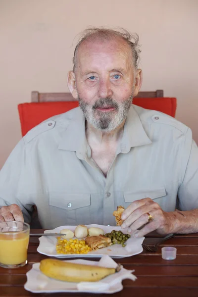 Senior eating healthy meal in residential care home — Stock Photo, Image