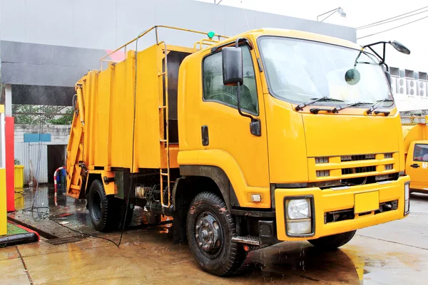 Yellow garbage truck