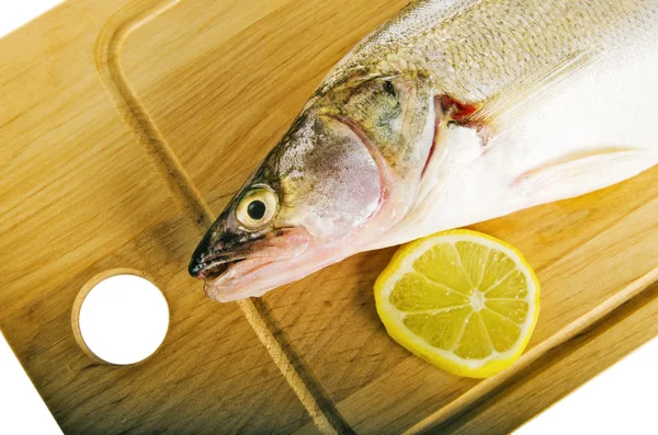 Pike perch on a wooden kitchen board, it is isolated on white — Stock Photo, Image