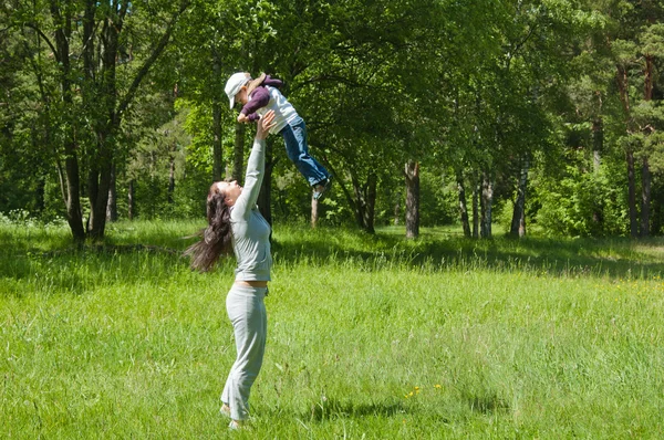 Mother raising her little child up high — Stock Photo, Image