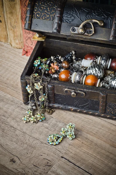 Cercueil avec bijoux et vieux livre sur une surface en bois — Photo