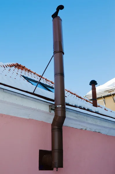 Metal chimney at a wall of a building — Stock Photo, Image