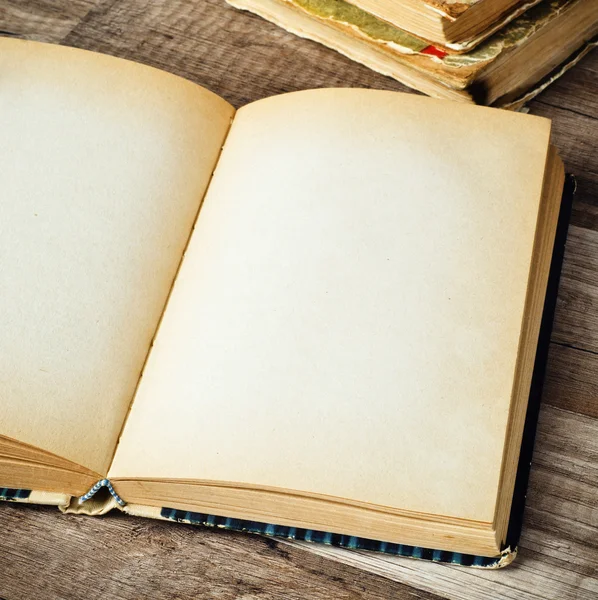 Open old book on a wooden surface — Stock Photo, Image