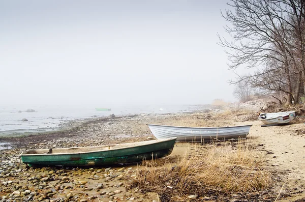 Altes Fischerboot an der nebligen Küste am Morgen — Stockfoto