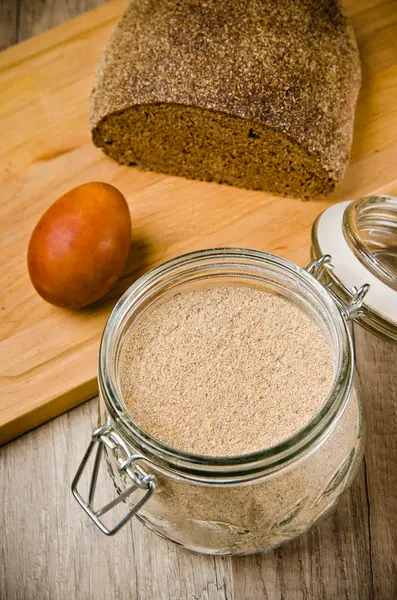 Black homemade bread, rye flour and egg , close-up — Stock Photo, Image