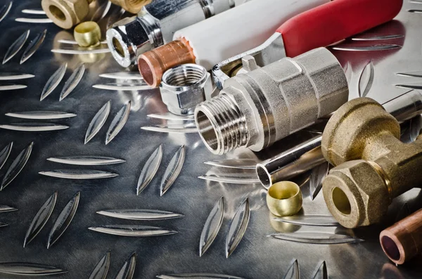 Plumbing inlet pipe valve on a metal surface — Stock Photo, Image