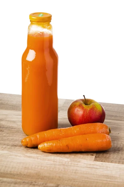 Bottle with carrots juice and an apple — Stock Photo, Image