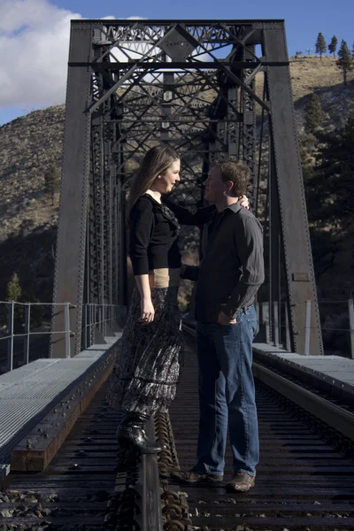 Young couple in love on the train tracks — Stock Photo, Image