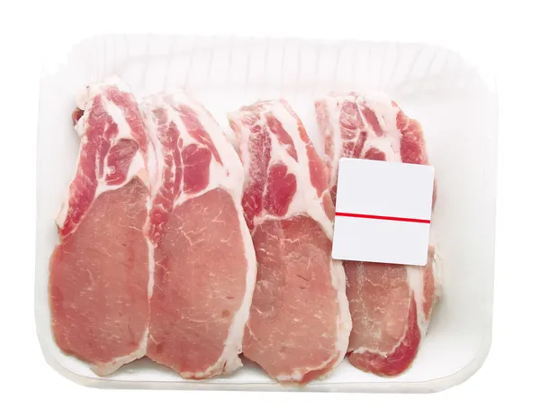 Costeletas de porco embaladas em um recipiente com uma etiqueta de preço — Fotografia de Stock