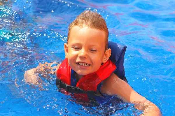 Nadšené dítě v vesta v bazénu vodní park — Stock fotografie