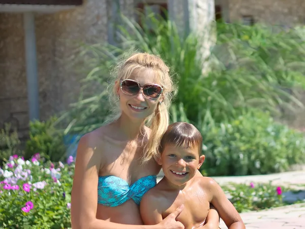 Happy mother and son in a spa hotel near pool — Stock Photo, Image
