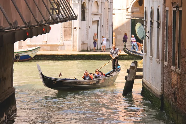 Gondoliere segelt mit Touristen in einer Gondel, Venedig, ital — Stockfoto