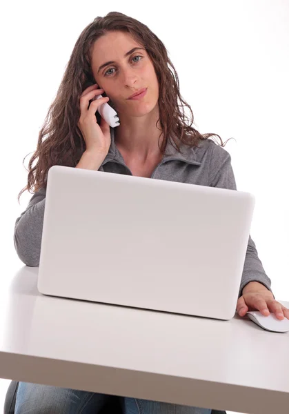 Woman with phone and computer Stock Picture