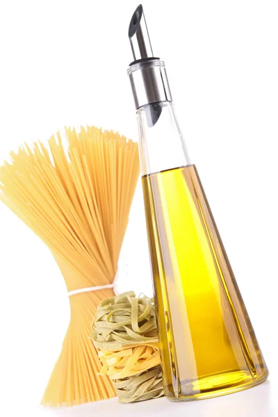 Isolated olive oil bottle and raw pasta — Stock Photo, Image