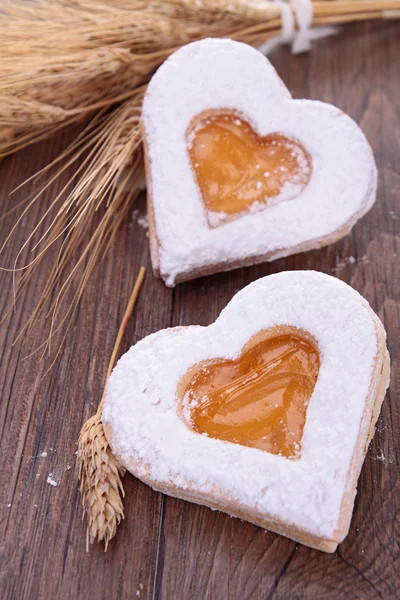 Biscuit heart shape on wood — Stock Photo, Image