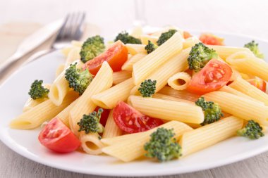 plate of pasta with tomato and broccoli