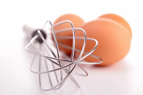 Whisk and eggs — Stock Photo, Image