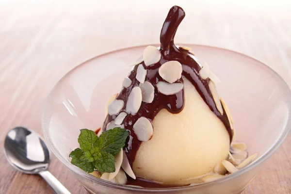 Pear with chocolate sauce and almonds — Stock Photo, Image