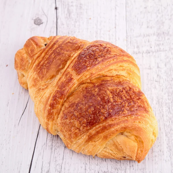 Croissant on wood — Stock Photo, Image