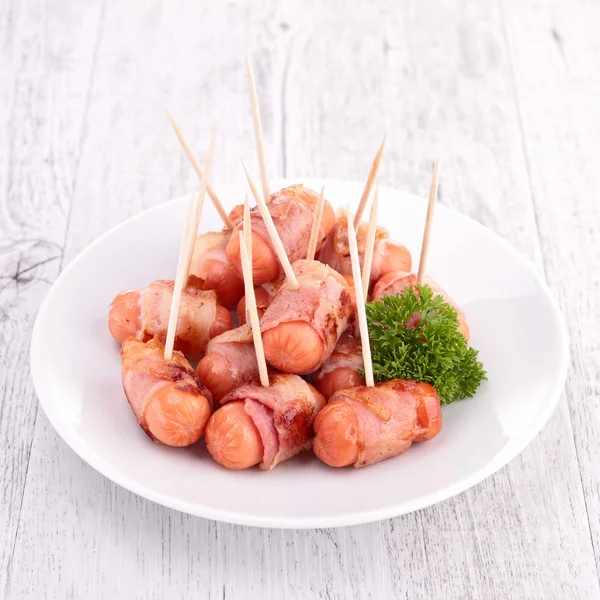 Sausage wrapped in bacon — Stock Photo, Image