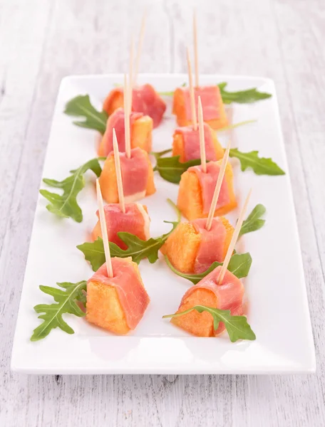 Appetizer, melon and prosciutto — Stock Photo, Image