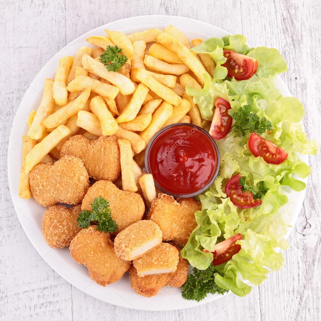 Chicken nuggets, french fries and salad
