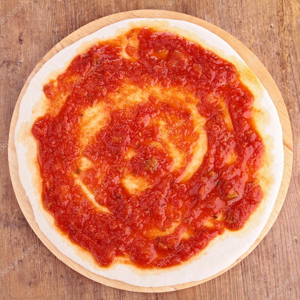 Pizza base with tomato sauce — Stock Photo © studioM #29436211