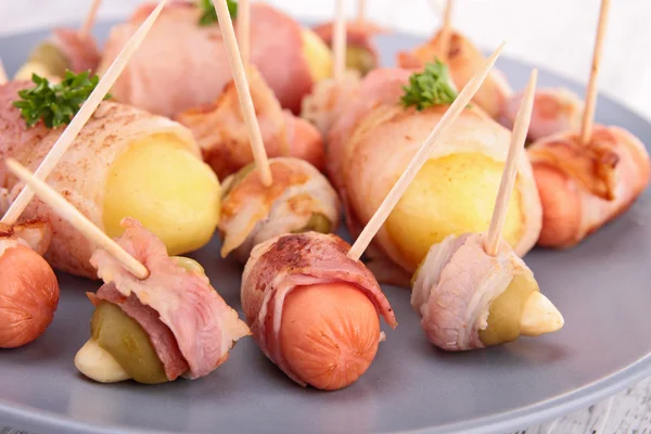 Appetizer wrapped in bacon — Stock Photo, Image