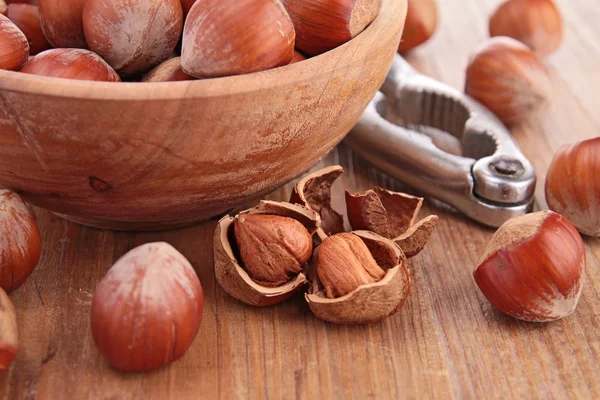 Bowl with hazelnuts and nutcracker — Stock Photo, Image