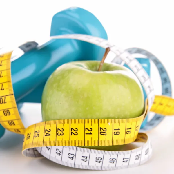 Green apple and measure tape — Stock Photo, Image