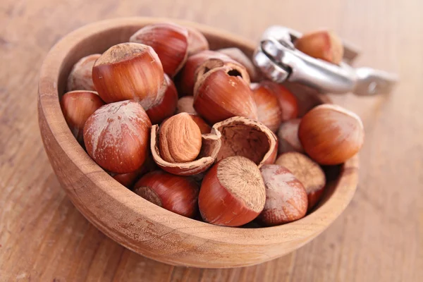 Bowl with hazelnuts and nutcracker — Stock Photo, Image