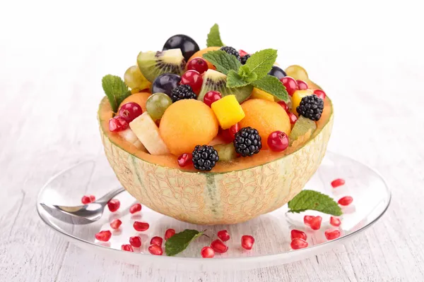 Fruit salad in melon bowl — Stock Photo, Image