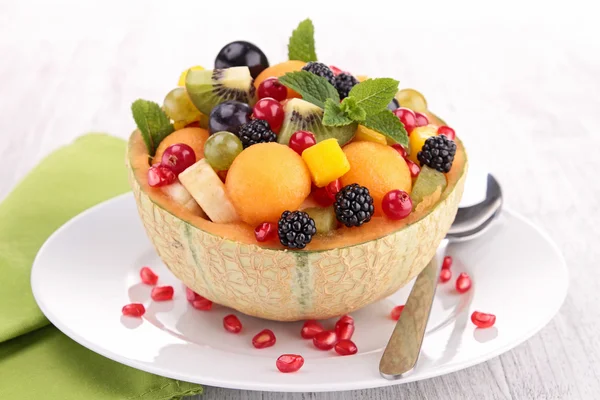 Fruit salad in melon bowl — Stock Photo, Image