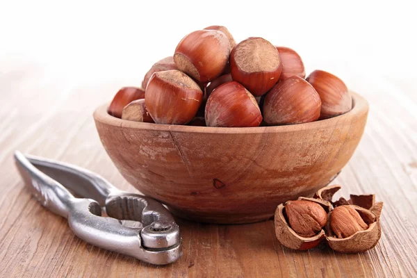 Bowl with hazelnuts and nutcracker — Stock Photo, Image
