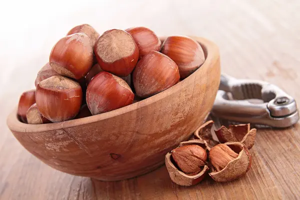 Bowl with hazelnuts and nutcracker — Stock Photo, Image