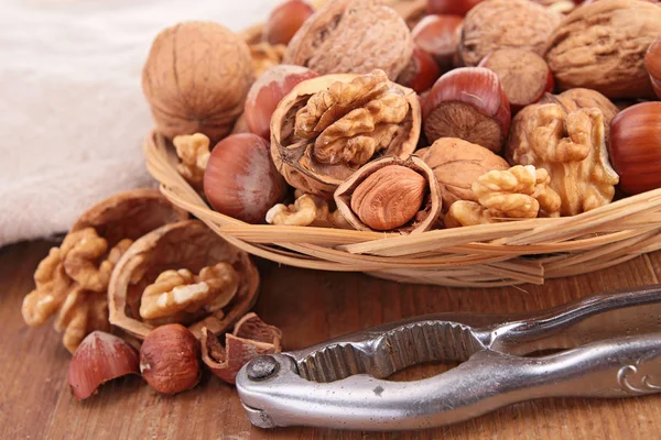 Bowl with assortment of nuts and nutcracker — Stock Photo, Image