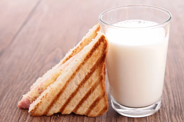 Glass of milk and sandwich — Stock Photo, Image