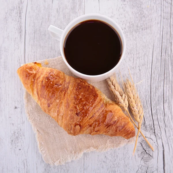 Croissant and coffee cup — Stock Photo, Image
