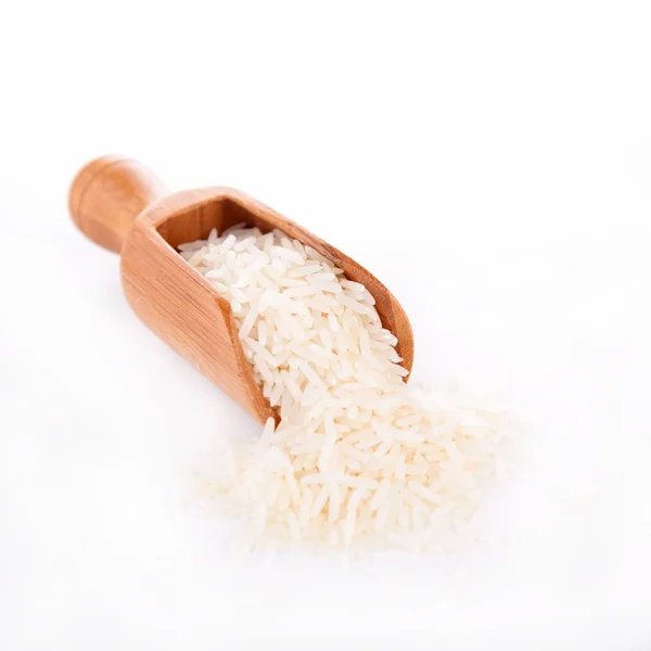 Raw rice on spoon — Stock Photo, Image