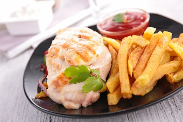 Chicken breast and fries Stock Picture