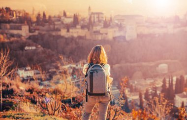 Ayakta duran kadın muhteşem panoramik manzaranın keyfini çıkarıyor.