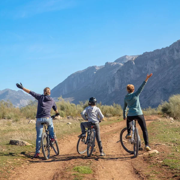 active family in bike and mountain landscape
