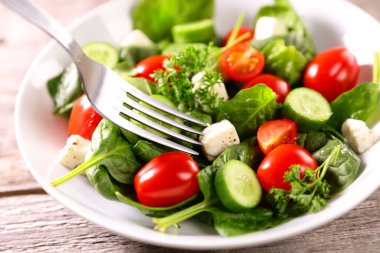 vegetable salad with tomato, cucumber,  spinach and feta cheese