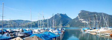 lake with boats and alps mountain