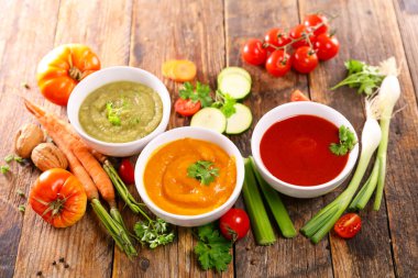 assorted of bowl of soup ( zucchini,  tomato and pumpkin or carrot)
