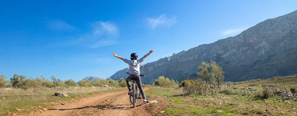 young boy happy on mountain bike