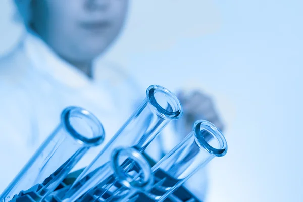 Test tubes closeup on blue background. — Stock Photo, Image