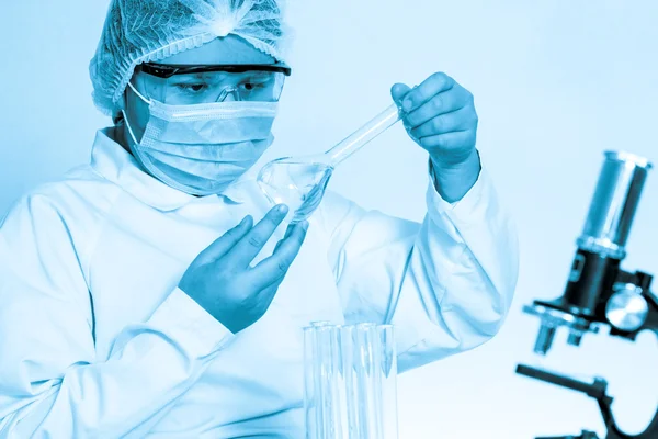 Assistente di laboratorio che analizza un liquido — Foto Stock