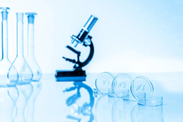 Microscope and test tubes used in research laboratory — Stock Photo, Image