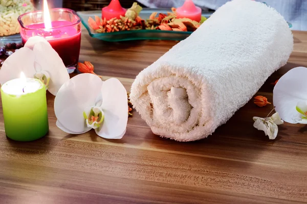 Concepto de bienestar y spa con velas, colección de toallas y parte de mesa de masaje . — Foto de Stock